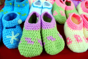 closeup of crocheted baby shoes on the market